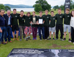 group shot of people holding a plaque