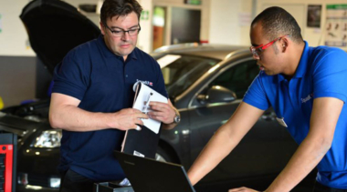 Two WorldSkills local heroes working on a car