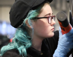 Photo of Billie-Jo in Automotive Technology competitor inspecting a car