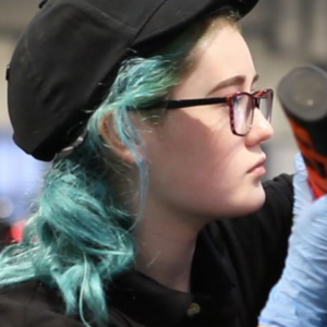 Photo of Billie-Jo in Automotive Technology competitor inspecting a car