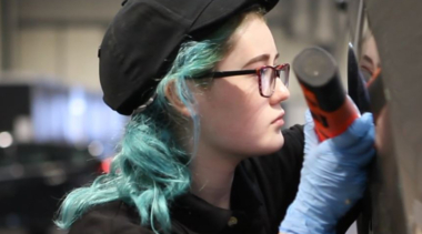 Photo of Billie-Jo in Automotive Technology competitor inspecting a car