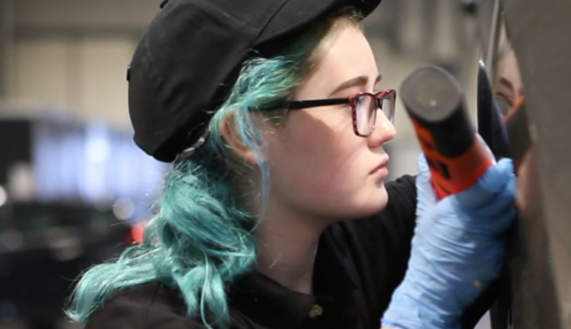 Photo of Billie-Jo in Automotive Technology competitor inspecting a car