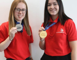 2 female students with medals