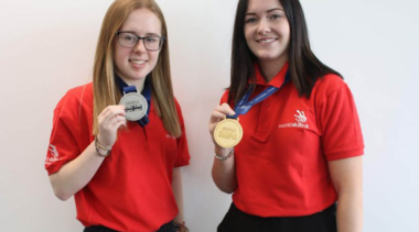 2 female students with medals