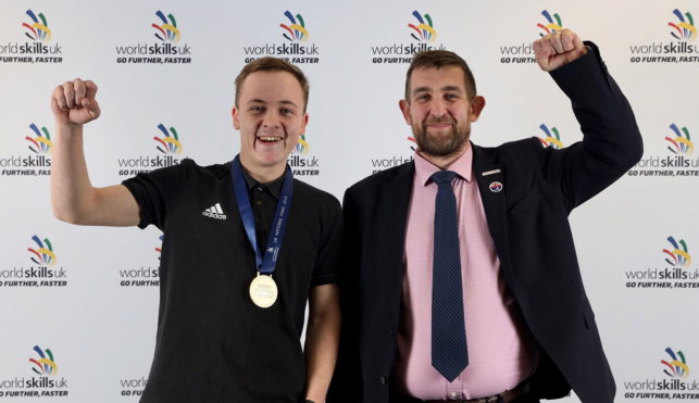 Photo of Dylan, Wall and Floor Tiling competitor celebrating his gold medal