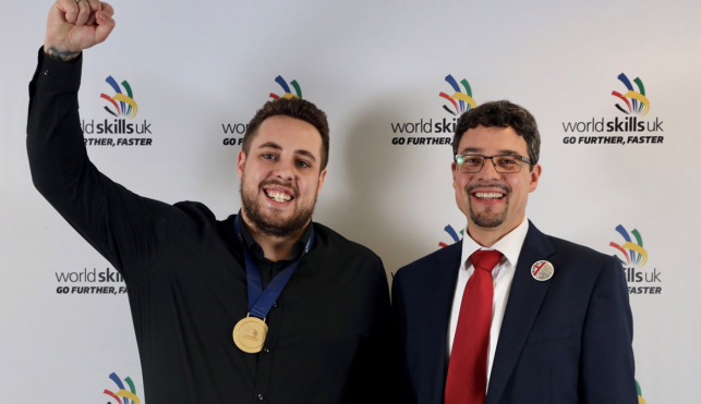 Photo of Lewis celebrating winning his gold medal as a chemical laboratory technician