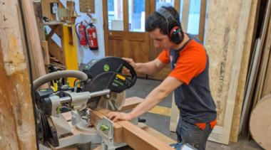 Photo of Ross sawing wood in joinery