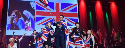 Photo of competitors carrying UK flags on stage at WorldSkills Gothenburg 2016