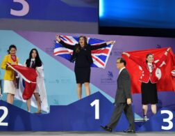 Photo of competitors carrying UK flags on stage at WorldSkills Abu Dhabi 2017