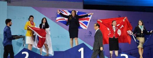 Photo of competitors carrying UK flags on stage at WorldSkills Abu Dhabi 2017