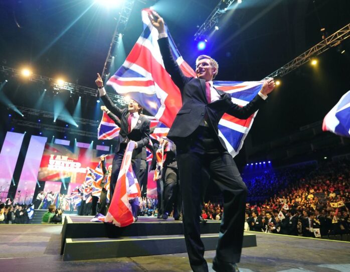 Photo of competitors carrying UK flags on stage at WorldSkills London 2011