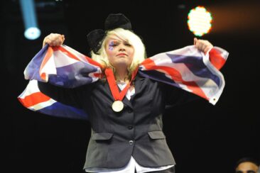 Photo of competitor with medal and flag at WorldSkills London 2011