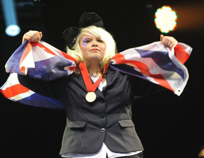 Photo of competitor with medal and flag at WorldSkills London 2011