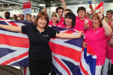 Photo of competitor with flag and supporters in WorldSkills Leipzig 2013