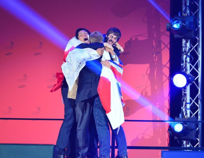 Photo of competitors on stage with flag at WorldSkills Leipzig 2013