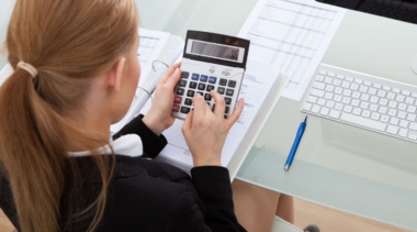 Photo of accountant typing into calculator