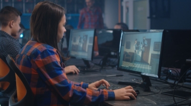 Photo of animator looking at computer screen animation