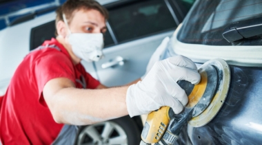 Photo of automotive refinishing using buffer machine on car surface