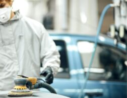 Photo of automotive refinishing using buffer machine on car surface