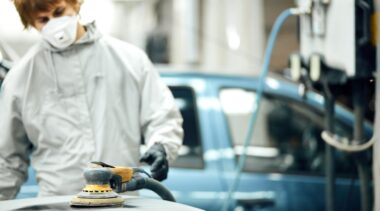 Photo of automotive refinishing using buffer machine on car surface