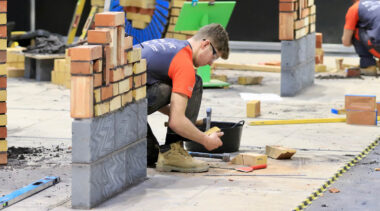 Young person competing in Bricklaying competition