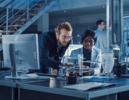 Photo of two CAD technicians examining a prototype