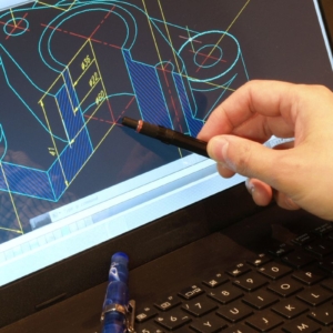 Photo of a CAD Technician pointing at a drawing on a computer screen