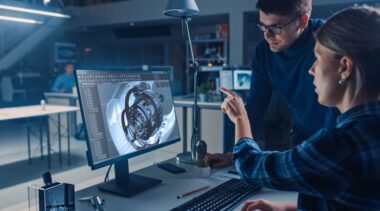 Photo of CAD technicians looking at computer screen display