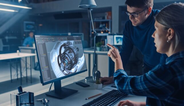 Photo of CAD technicians looking at computer screen display