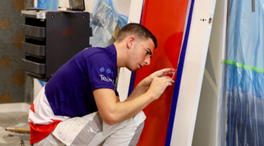 Photo of Painting and Decorating competitor Callum painting at WorldSkills Kazan