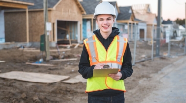 Photo of construction project manager on site with a clipboard