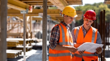 Photo of two construction project managers reviewing plans