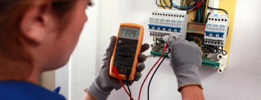 Photo of electronics technician and fuse box