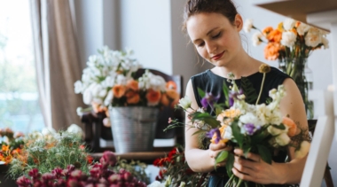 Photo of florist clutching a bunch of flowers