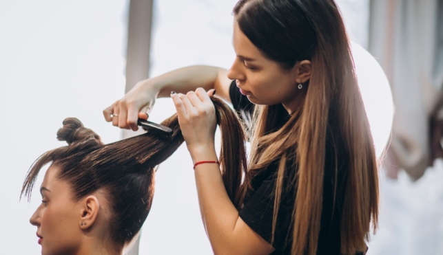 Photo of hairdresser cutting customer's hair