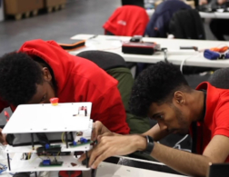 Young people competing in Industrial Robotics competition