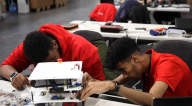 Young people competing in Industrial Robotics competition