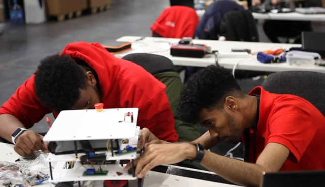 Young people competing in Industrial Robotics competition