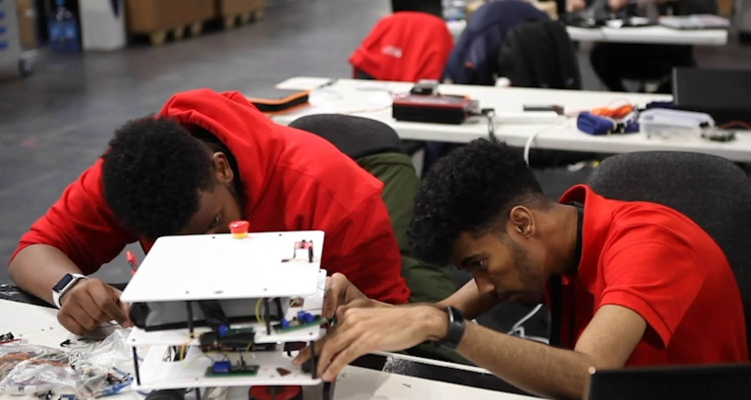 Young people competing in Industrial Robotics competition