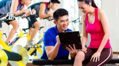 Photo of personal trainer reviewing chart with client