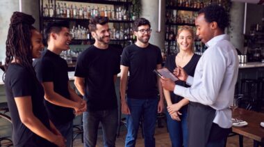 Photo of restaurant manager chatting to waiting staff