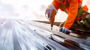 Photo of roofer installing a metal roof