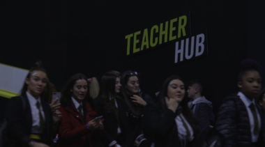 teacher hub with students below sign