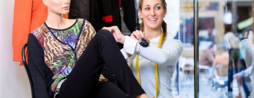 Photo of a young Visual Merchandiser dressing a mannequin