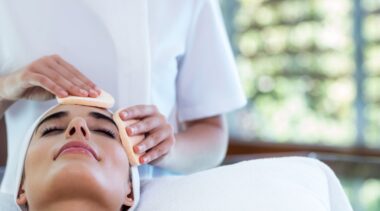 Photo of beauty therapist giving customer a facial