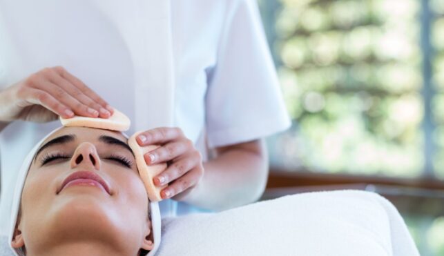 Photo of beauty therapist giving customer a facial