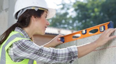 Photo of bricklayer checking bricks are level