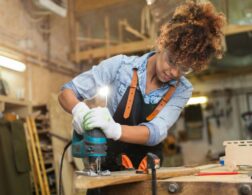 Photo of carpenter using power tools on piece of wood