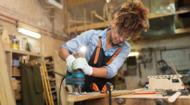 Photo of carpenter using power tools on piece of wood