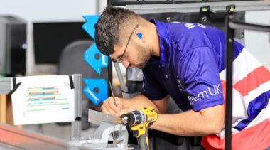 Photo of Isaac competing internationally in the Manufacturing Team Challenge